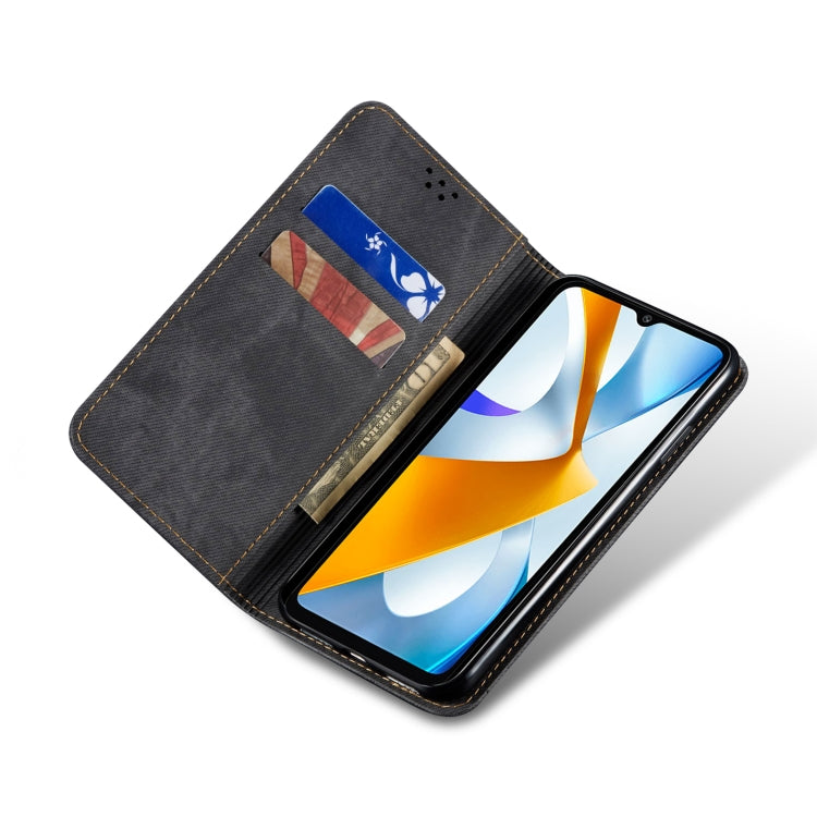 Denim-textured flip phone case with card slot window, open stand, and gold trim.