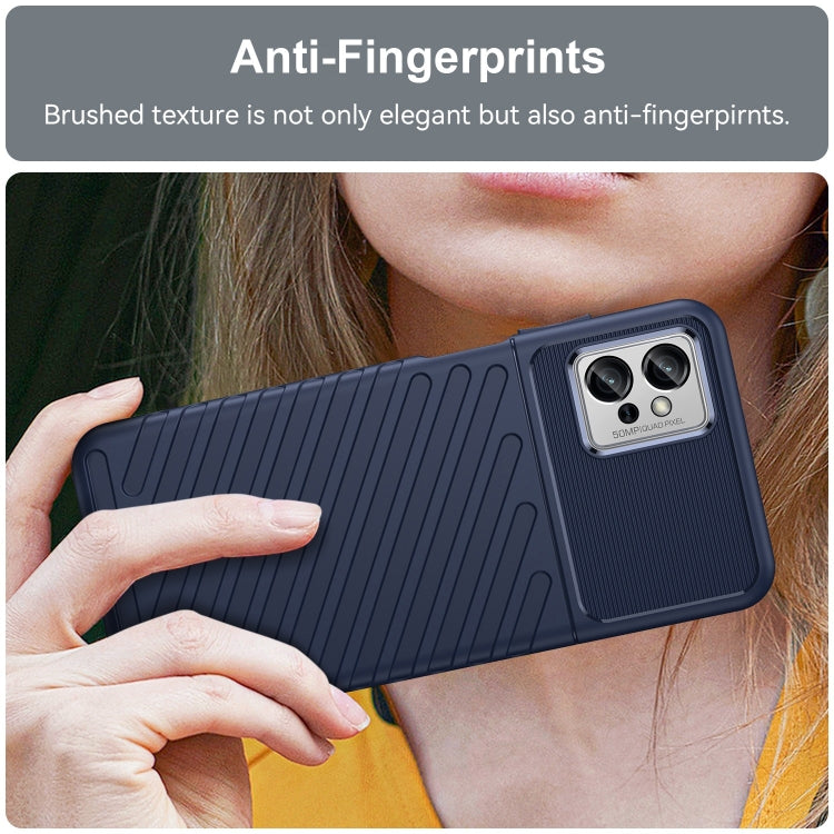 Blue shockproof TPU phone case held in hand, textured back and camera area