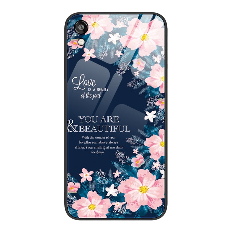 Glass phone case with pink blossoms and a floral design on a dark blue background.