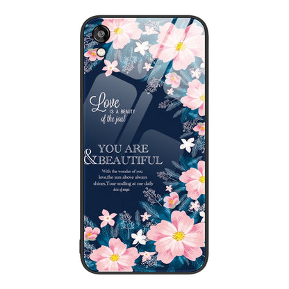 Glass phone case with pink blossoms and a floral design on a dark blue background.