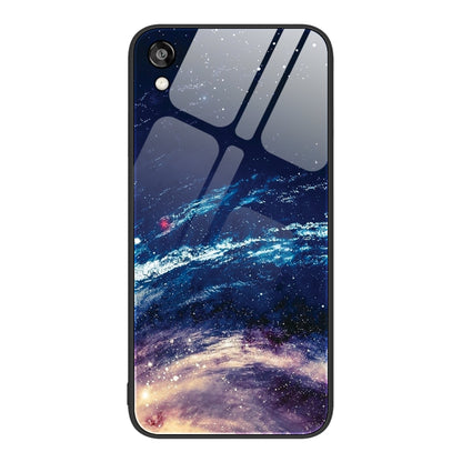 Glass phone case with a starry night scene and blue galaxy landscape illustration.