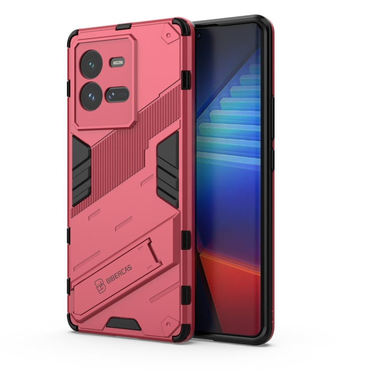 Light red shockproof phone case with textured armor design and raised camera cutouts