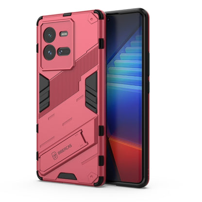 Light red shockproof phone case with textured armor design and raised camera cutouts