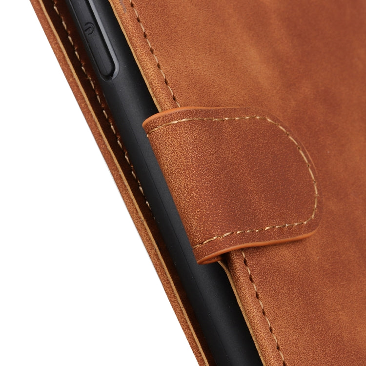 Brown leather phone case with stitched side strap and rounded cutout panel