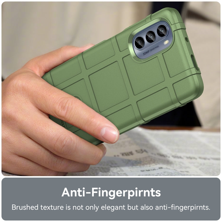 Green rugged TPU phone case in hand with triple camera cutout