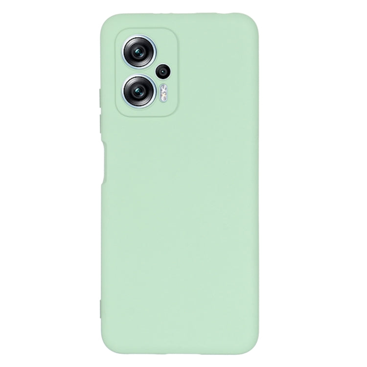 Green silicone phone case with dual camera cutouts and raised edges