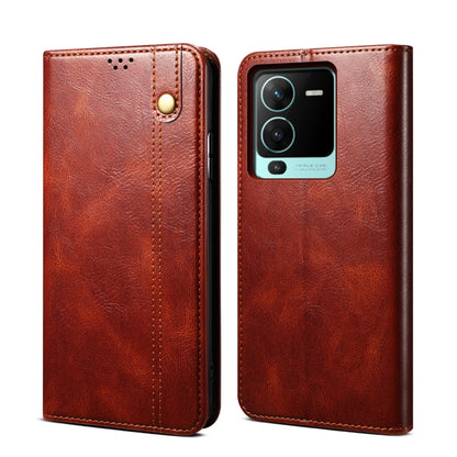 Brown leather flip phone case with magnetic snap and camera cutout, textured finish