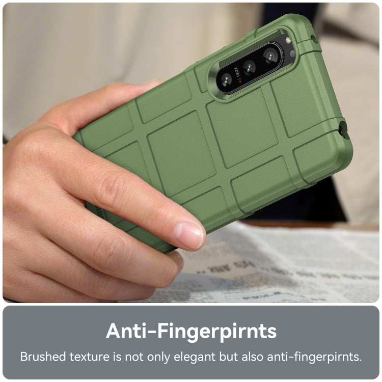 Green rugged TPU phone case in hand, textured back panel