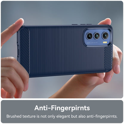 Blue brushed TPU phone case being held with textured grip and camera cutout