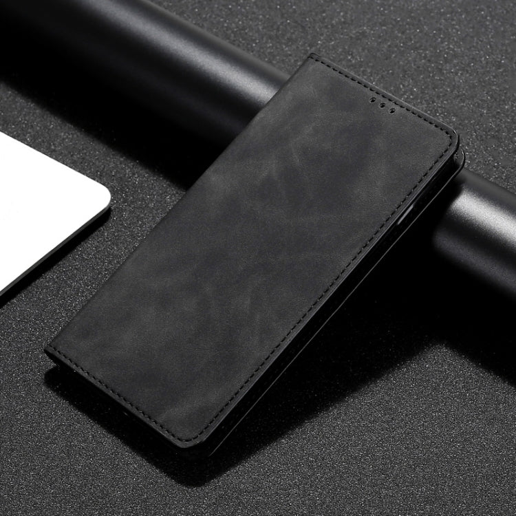 Magnetic flip leather phone case in black, close-up of stitched edge and smooth texture