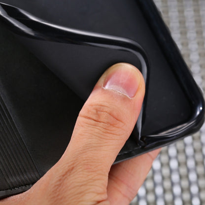 Black leather magnetic flip phone case corner, close-up showing hand grip