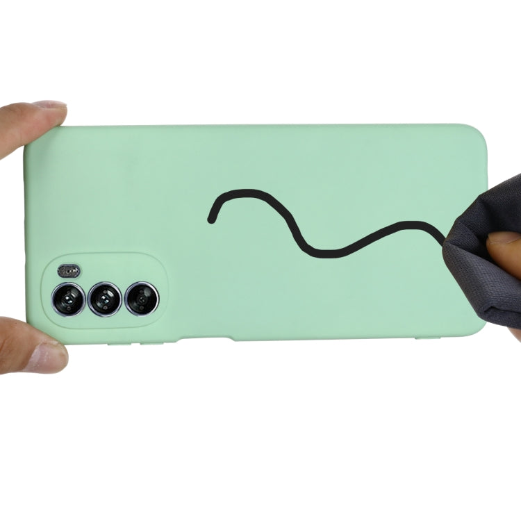 Mint green silicone phone case showing grip edge and triple camera area