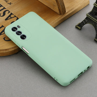 Mint green liquid silicone phone case in angled view with bottom port openings