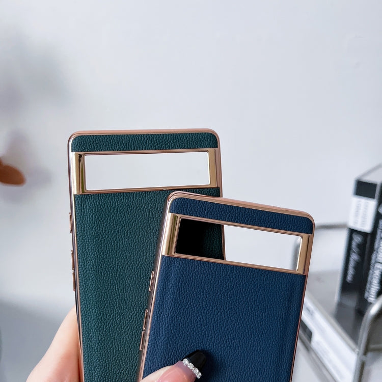 Pair of teal and navy textured leather phone cases with rectangular card-slot windows