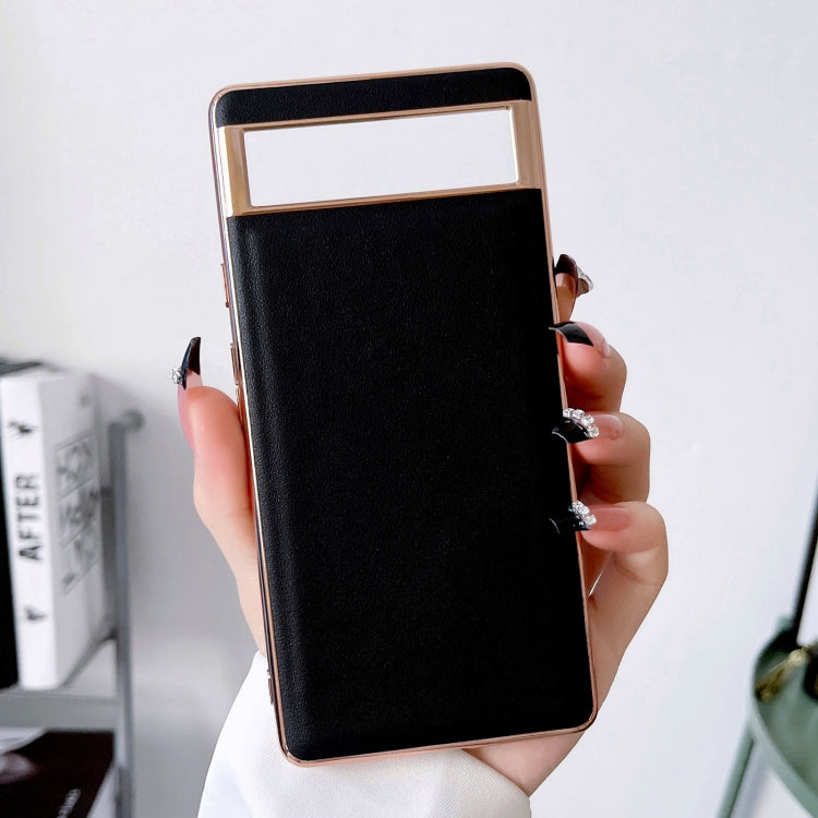 Genuine leather phone case with black front cover and camera cutout, held in hand