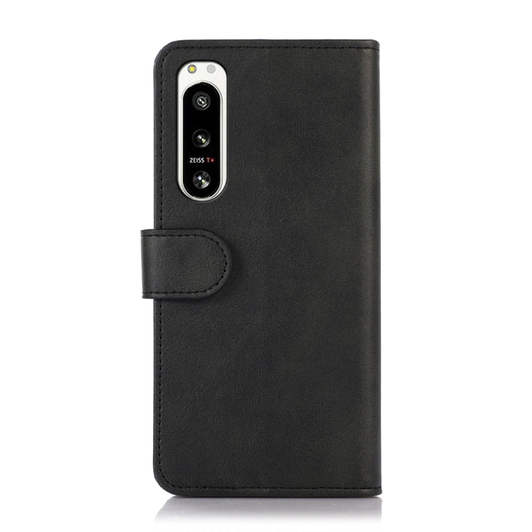 Black textured leather-style phone case with cutout for rear camera and flash