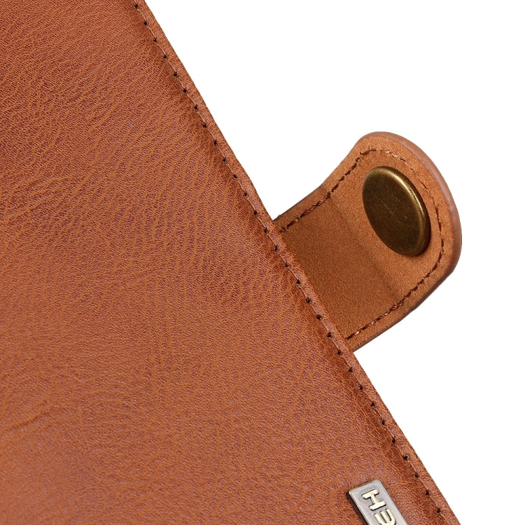 Brown leather flip phone case close-up of magnetic snap and stitched strap.