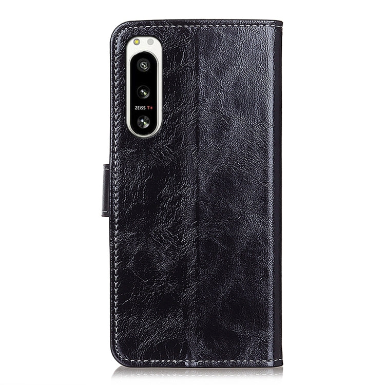Black textured leather flip phone case with camera cutout and side openings.