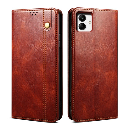 Brown oil-wax leather phone case with embossed texture, stitched edges, and cutouts