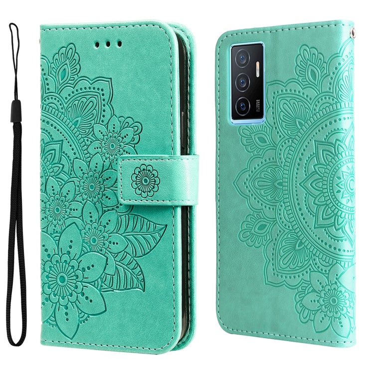 Mint-green embossed leather wallet phone case with floral mandala pattern, magnetic strap, and wrist lanyard.
