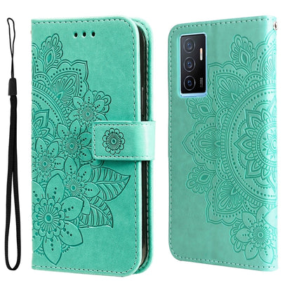 Mint-green embossed leather wallet phone case with floral mandala pattern, magnetic strap, and wrist lanyard.