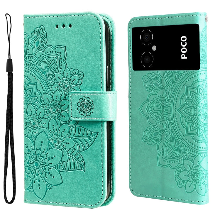 Mint-green embossed leather wallet phone case with floral design; rear cameras visible; magnetic closure strap.