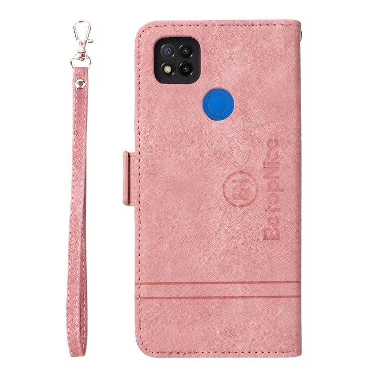 Pink leather phone case with camera cutout, blue button, and wrist strap