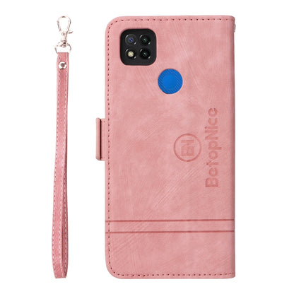 Pink leather phone case with camera cutout, blue button, and wrist strap