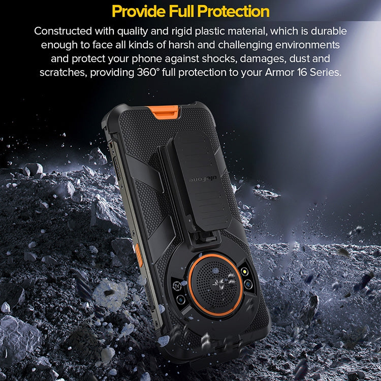 Black rugged phone case with orange accent insert and back clip, shown on debris.