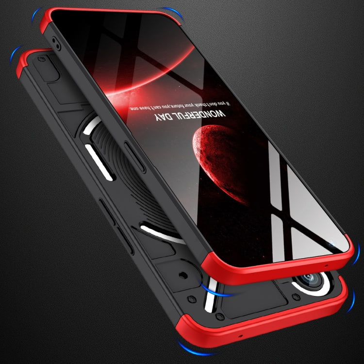 Black phone case with red trim and blue corner bumpers; wireless charging pad