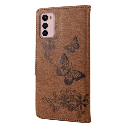 Brown butterfly embossed leather phone case with cutout for camera and flash.