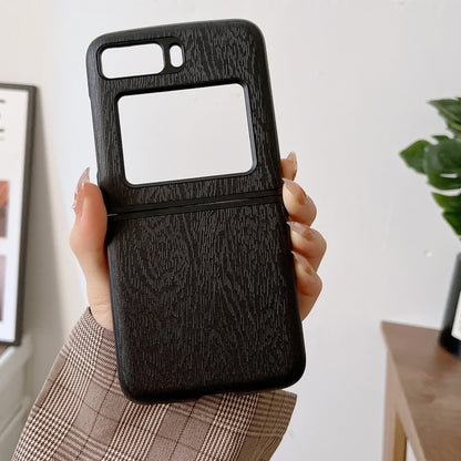 Black wood-texture PU phone case held in hand, camera and screen cutouts