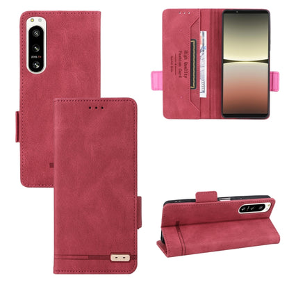 Red leather flip phone case with camera cutout and magnetic closure strap