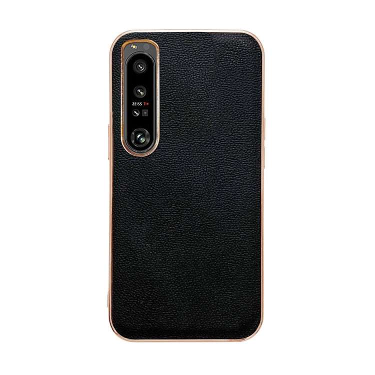 Black leather phone case with textured finish; camera cutout and raised lip details.