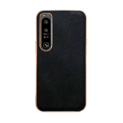 Black leather phone case with textured finish; camera cutout and raised lip details.