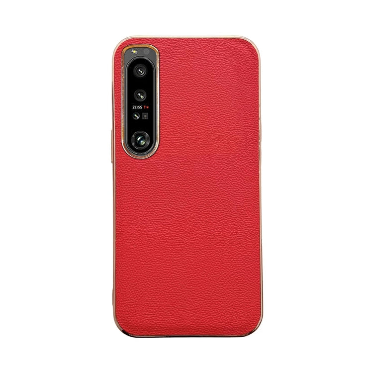 Red leather phone case with textured finish; dual camera cutout and slim edges.