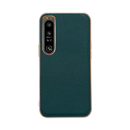 Dark green leather phone case with textured finish; dual camera cutout and raised bezel.