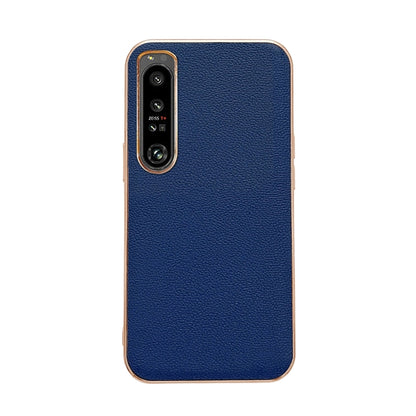 Dark blue leather phone case with textured finish; dual camera cutout and protective rim.