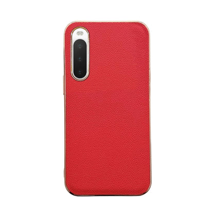 Red leather phone case with textured finish; single camera cutout and protective rim.