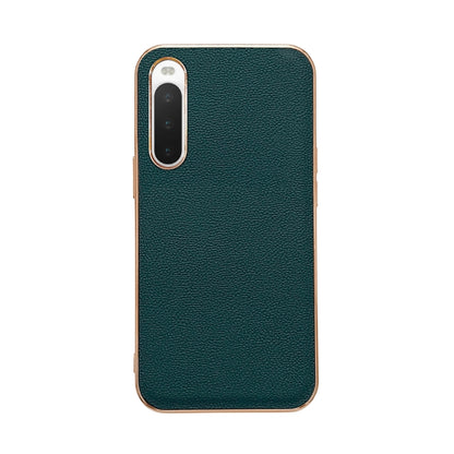 Dark green leather phone case with textured finish; single camera cutout with raised bezel.