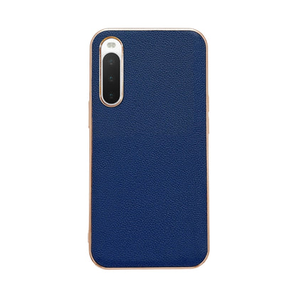 Dark blue leather phone case with textured finish; single camera cutout and protective rim.
