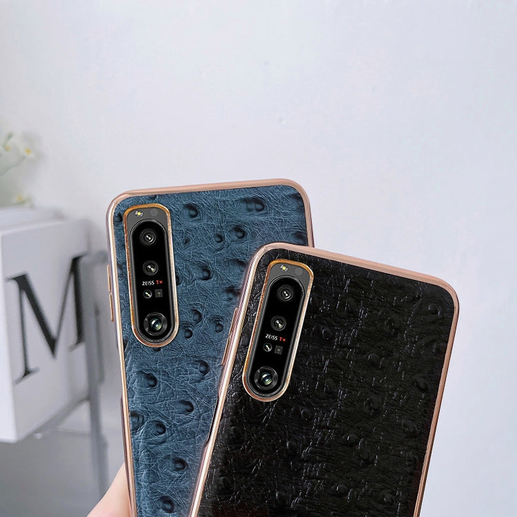 Set of blue and black ostrich-textured leather phone cases with dual camera cutouts