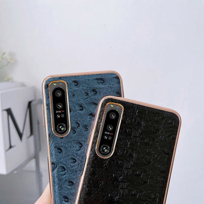 Set of blue and black ostrich-textured leather phone cases with dual camera cutouts