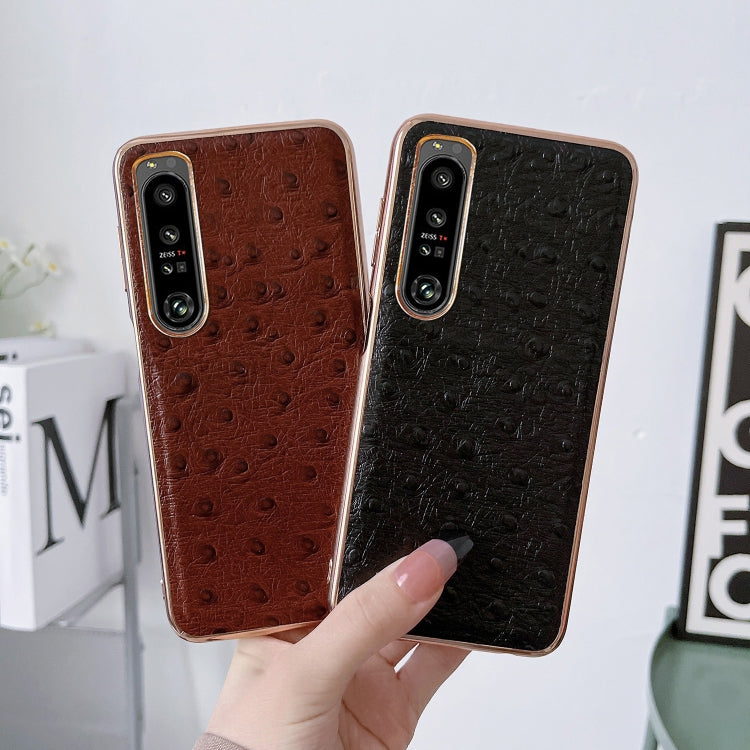 Leather phone cases with ostrich-texture finish; camera cutouts, brown and black.