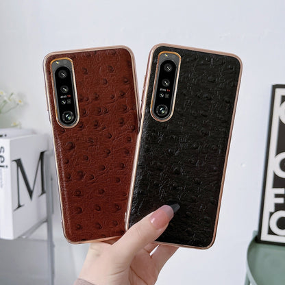 Leather phone cases with ostrich-texture finish; camera cutouts, brown and black.