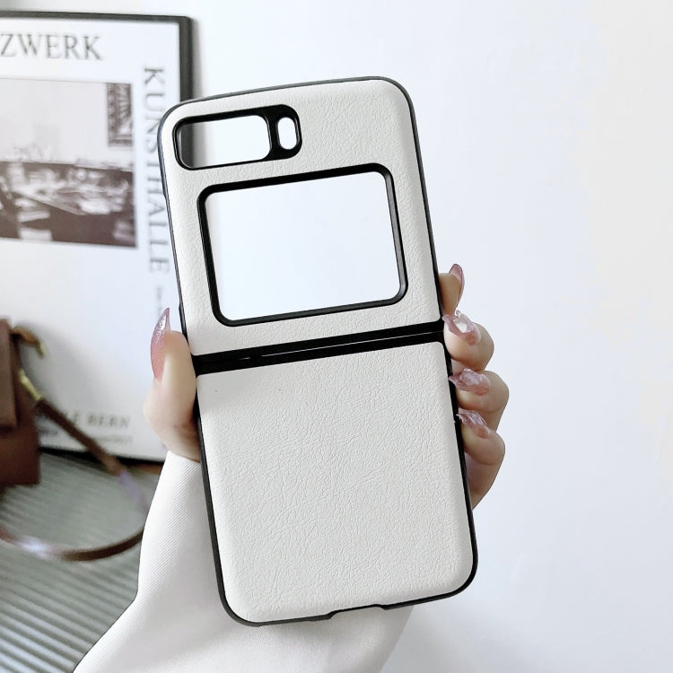 Two-tone litchi-texture PU phone case, white with black trim; held in hand.