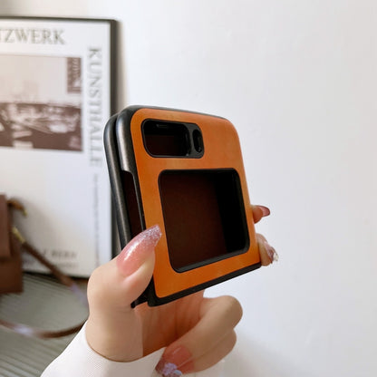 Two-tone litchi-texture PU phone case, orange with black trim; held from back view.
