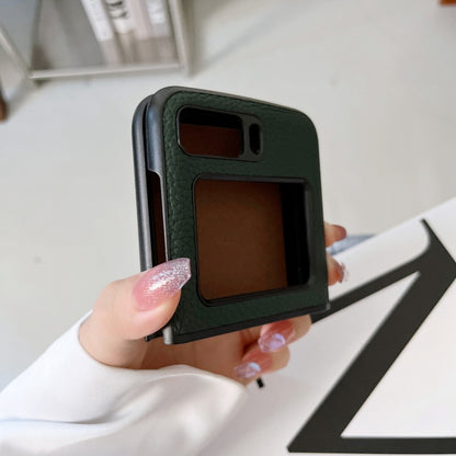 Green genuine leather phone case held in hand, showing camera and port cutouts.