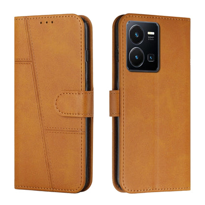 Tan leather flip phone case with buckle strap and card slot, stitched seam detailing