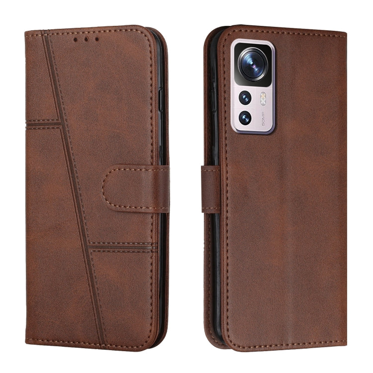 Dark brown leather wallet phone case with buckle strap and stitched accents, front and back view
